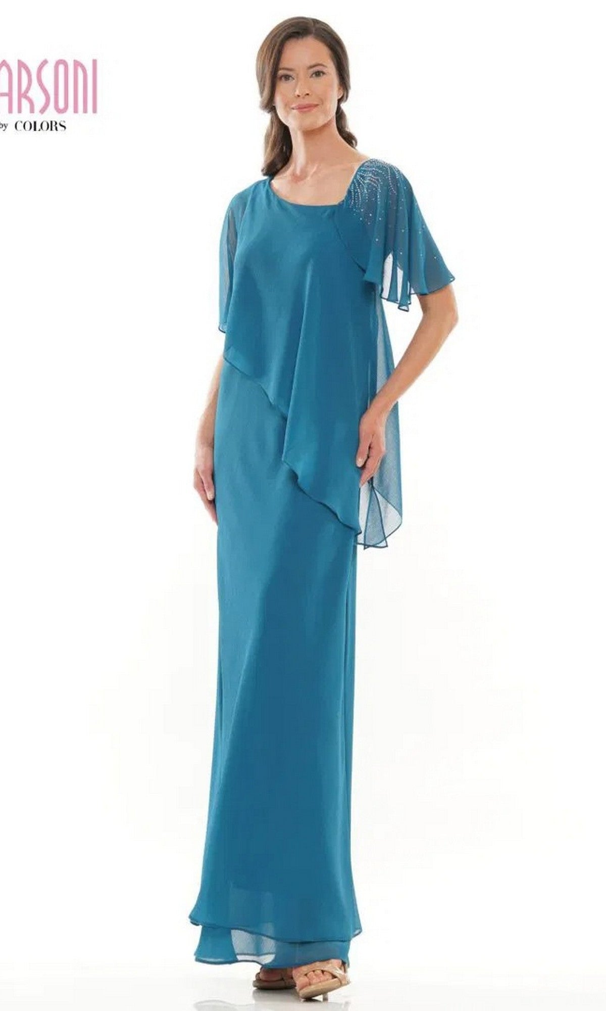 A woman stands against a plain background wearing the Marsoni M313 long formal dress in teal, featuring layered chiffon fabric and short, sheer sleeves.